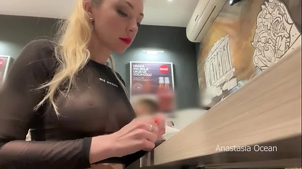 Flashing her big boobs in transparent top in public cafe.