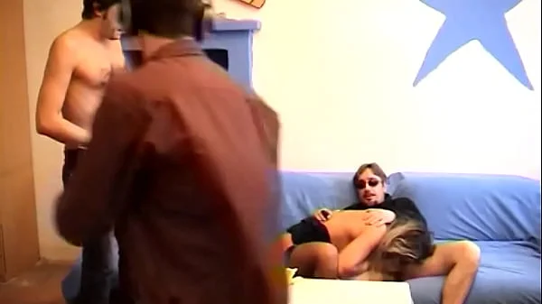 Sexy blonde in front of the camera gets fucked by two cocks in her mouth and butt
