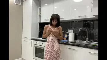 Stunning busty bitch masturbates in the kitchen before her lover arrives