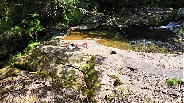 An impudent Voyeur Fingered a Naked Milf on a Nudist Beach in the Forest