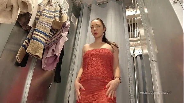 I try on clothes in fitting room with open curtain.
