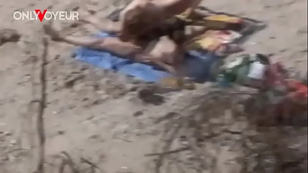 Beach Voyeur. Young nudist couple enjoying sex on the beach