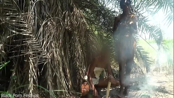 2 African tribe girls jerking off their chief with their asses in the river