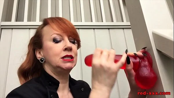 Busty mature Red XXX fucks her dildo on the stairs