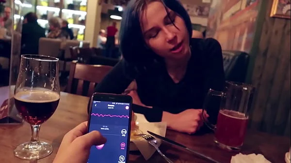 I took control of my stepsister's vibrator in the bar and brought her to orgasm.