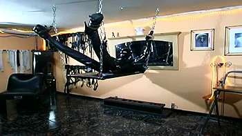 Humiliating chaining body stretching in latex dress