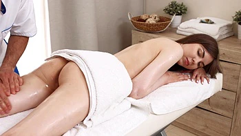 Brunette teen Alice Xo gets her shaved pussy rubbed with oil.