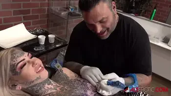 Sascha plays with Amber Luke while she gets tattooed