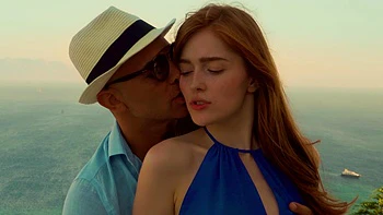 A couple enjoys passionate sex with a stunning redhead, showcasing Jia Lissa’s fiery charm.