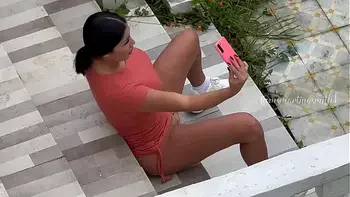 Martina is recorded from afar by a fan while she masturbates in public