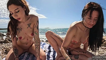 Two sexy brunettes fuck wild on the beach