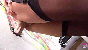 This Gorgeous, Dark-haired, Smoking Lady Enjoys A Glory Hole While Masturbating In A Cubicle